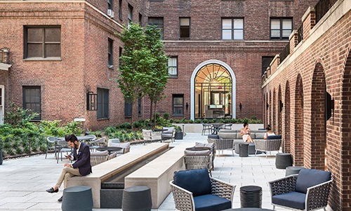 Large courtyard with brick accents and plenty of areas for seating.